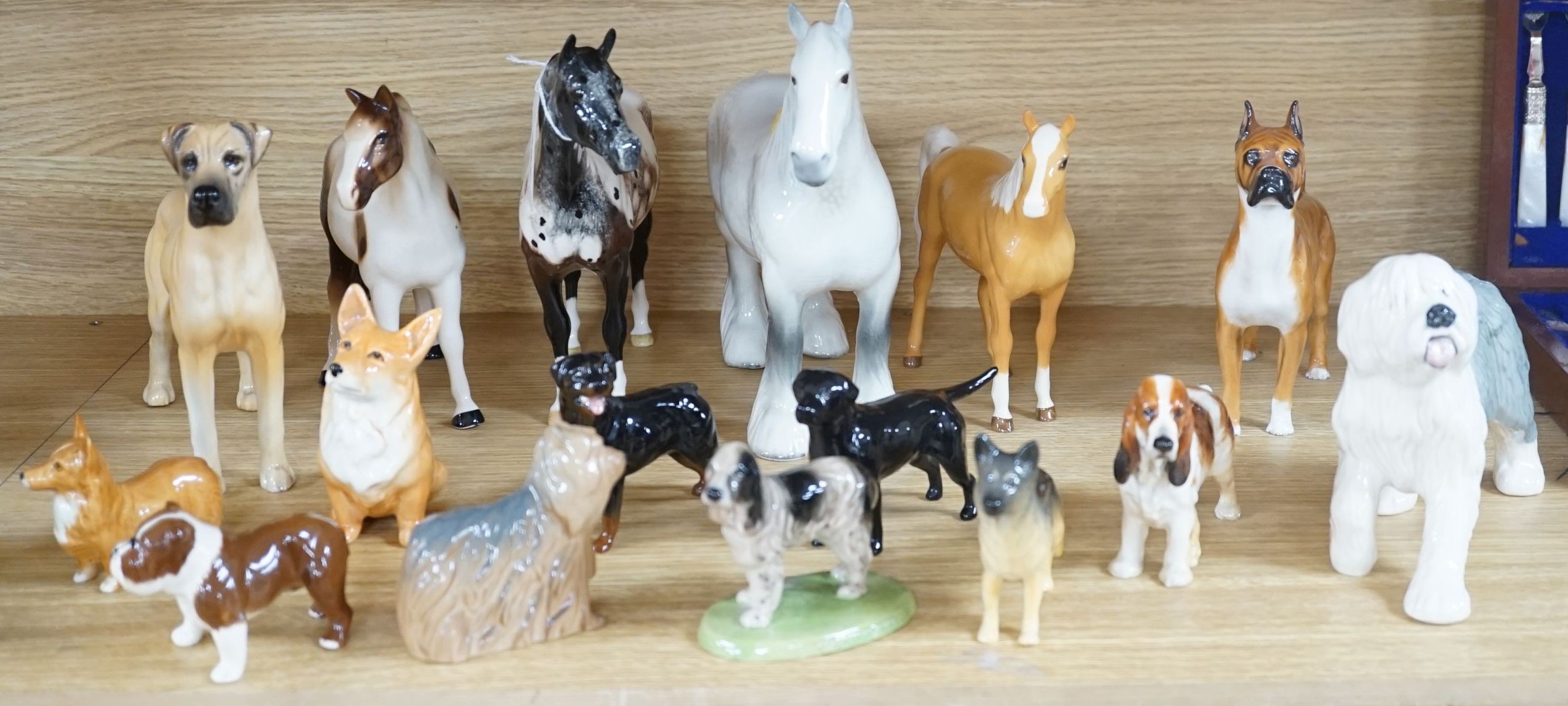 A large quantity of mixed Doulton, Beswick, dogs and horses, largest, Beswick shire horse 23cms high.
